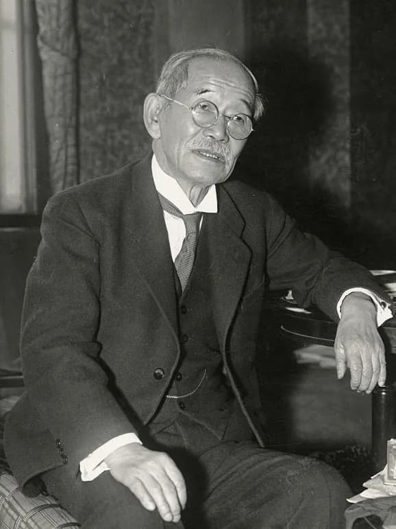 Portrait of Jigorō Kanō in a dark suit and tie, around 1937, the year before his death.