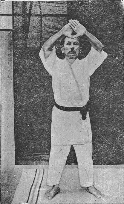Portrait photograph of Funakoshi Gichin in a dark kimono, taken in 1924.