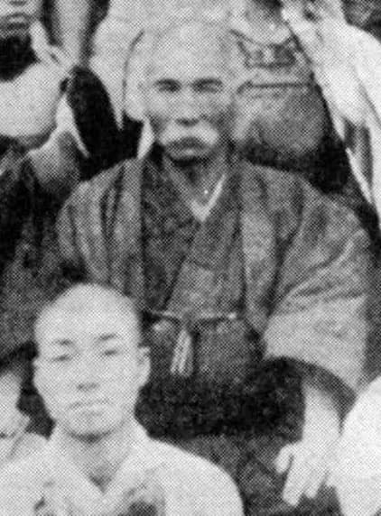 Portrait photograph of Itosu Ankō, an elderly Okinawan man with a white beard, around 1910.