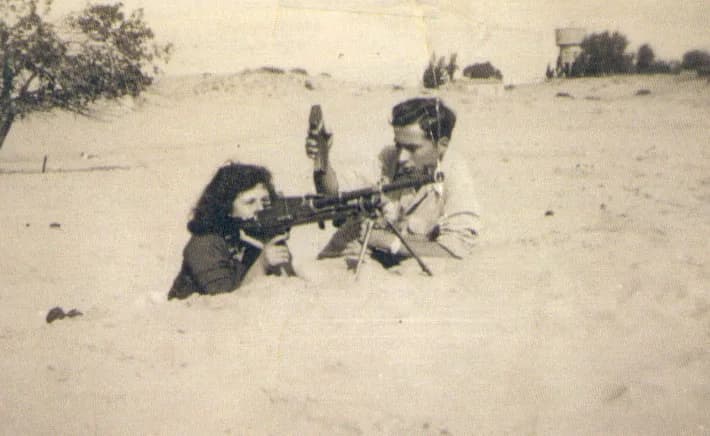 Black-and-white photograph of members of the Jewish underground force Hish training in a field before 1948.