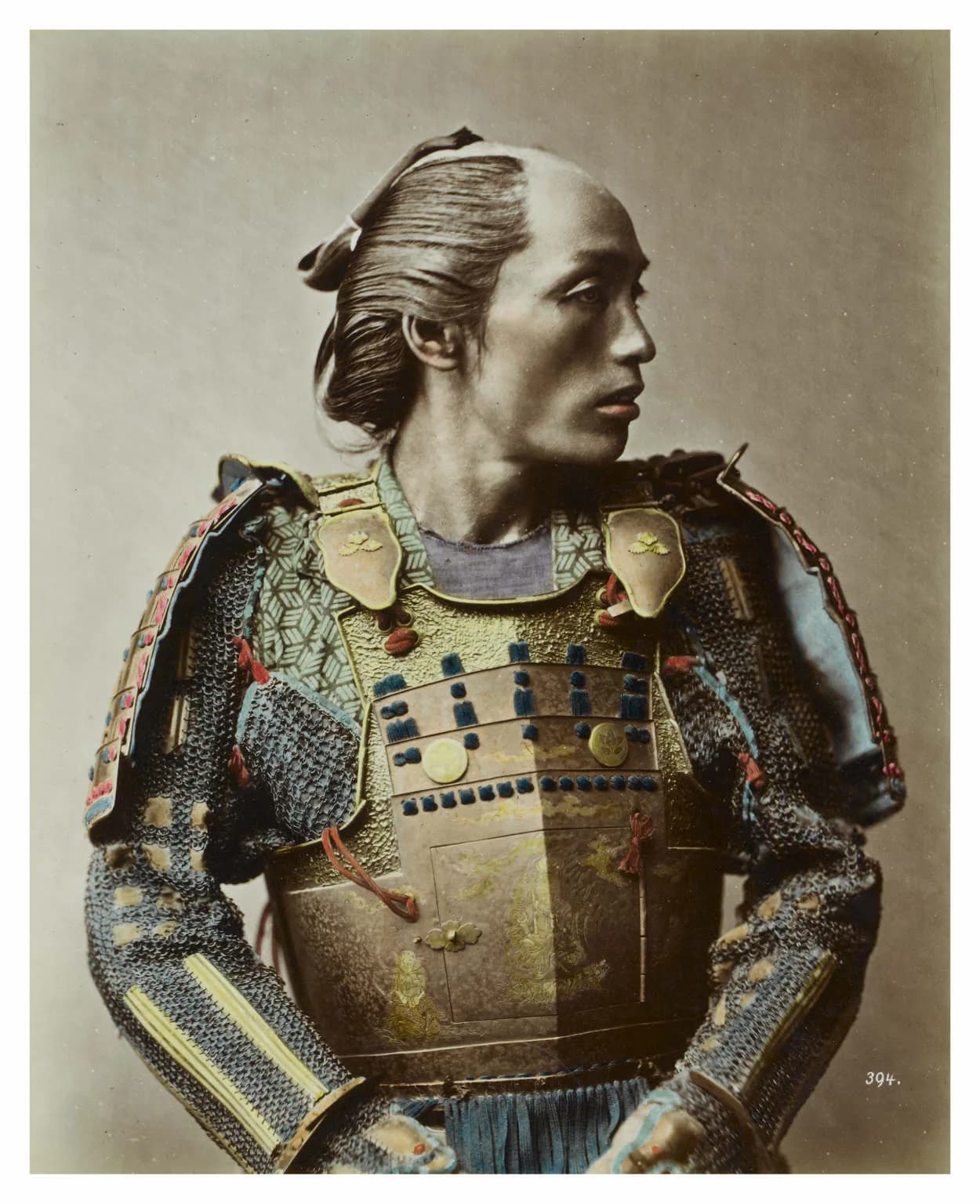 Studio portrait of a samurai in armour holding a sword, by Raimund von Stillfried, 1881.