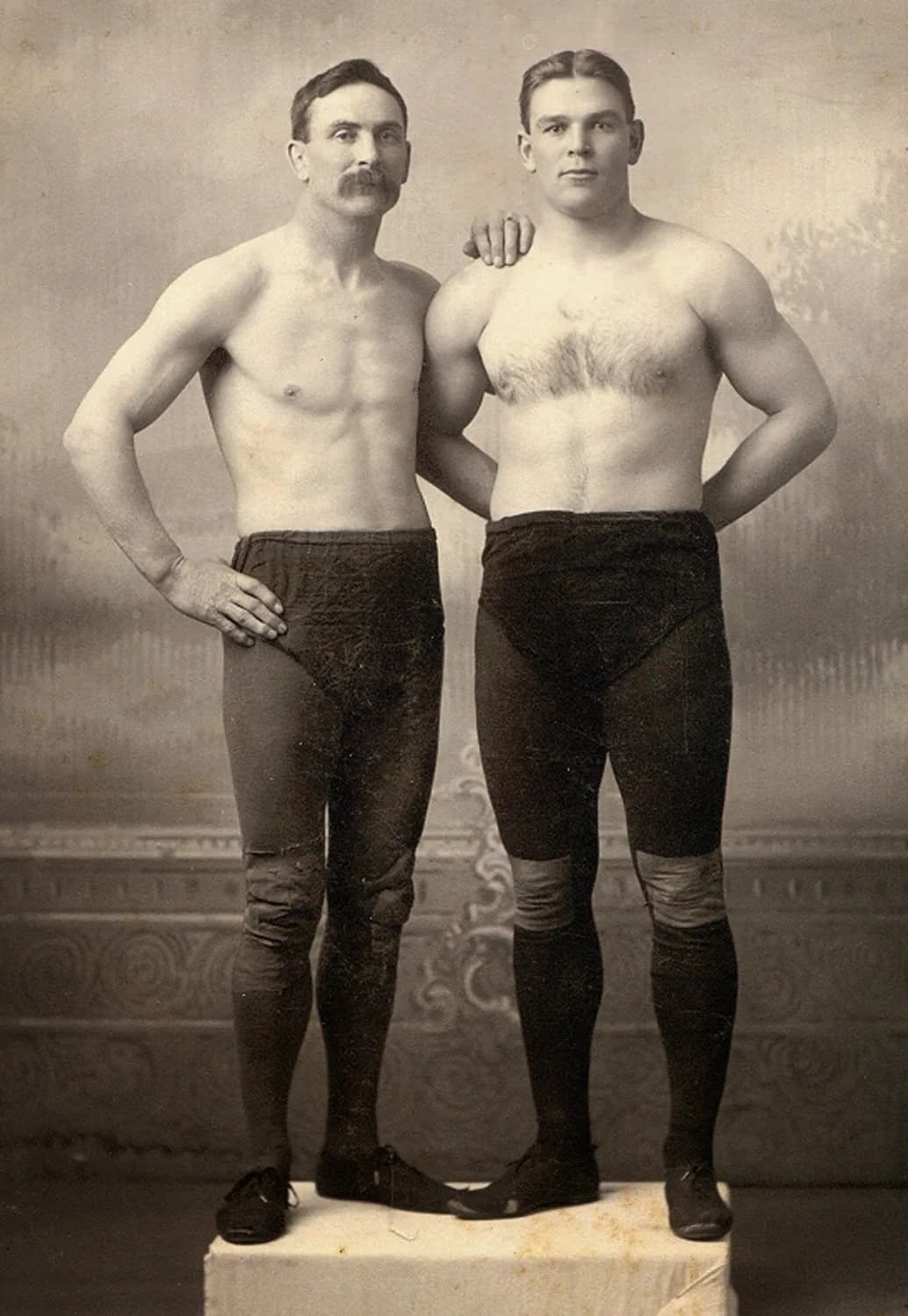 Photograph of Martin “Farmer” Burns and Frank Gotch posing in wrestling attire around 1905.