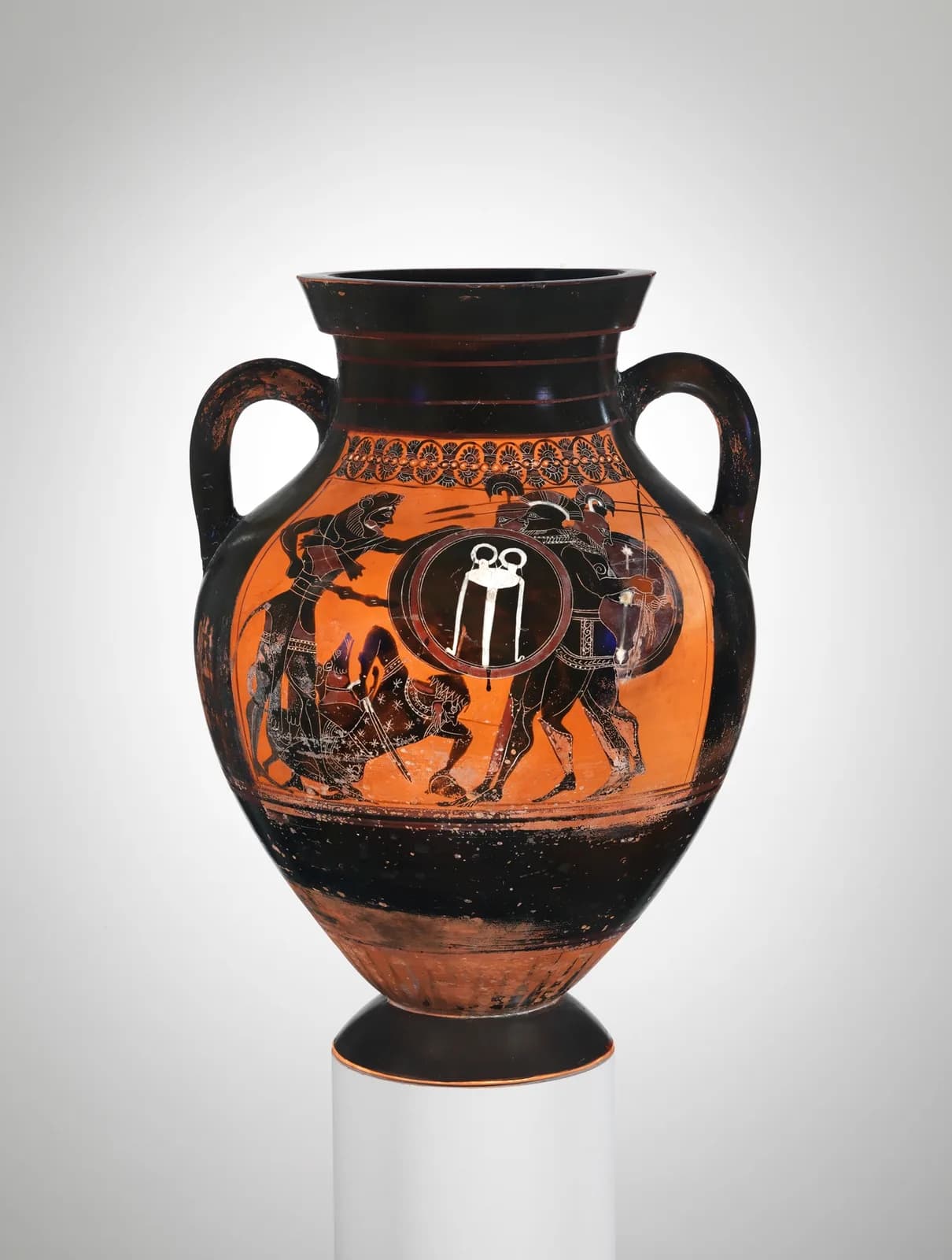 Black-figure Greek amphora showing two nude wrestlers locked together with their trainer beside them.