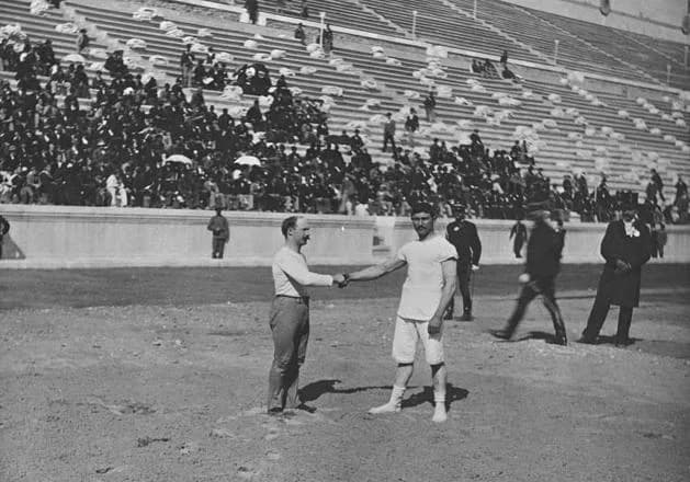 Photograph from 1896 of Carl Schuhmann wrestling an opponent in the stadium at the first modern Olympic Games in Athens.